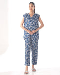 Woman wearing a blue floral outfit on a white background