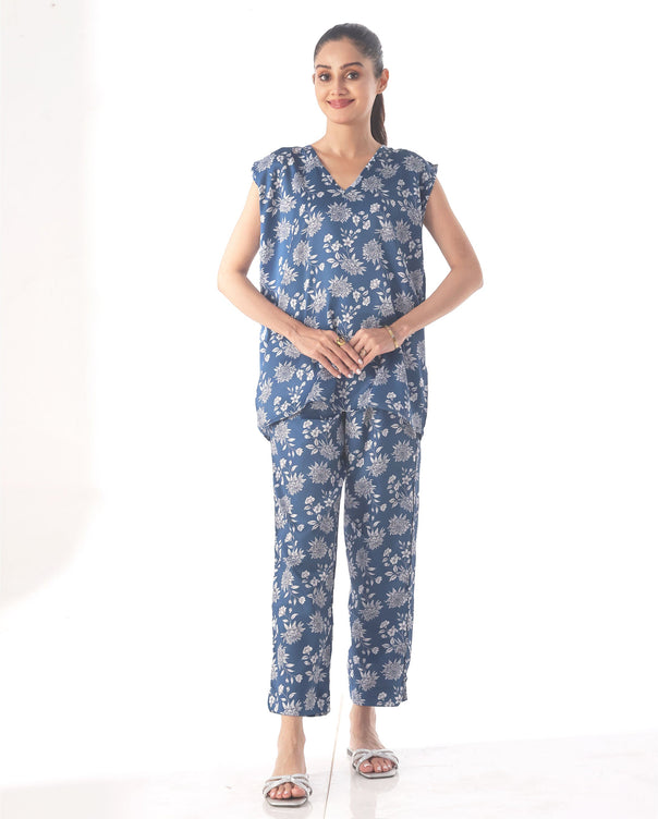 Woman wearing a blue floral outfit on a white background